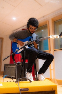 Jyair Washington playing guitar during a studio session